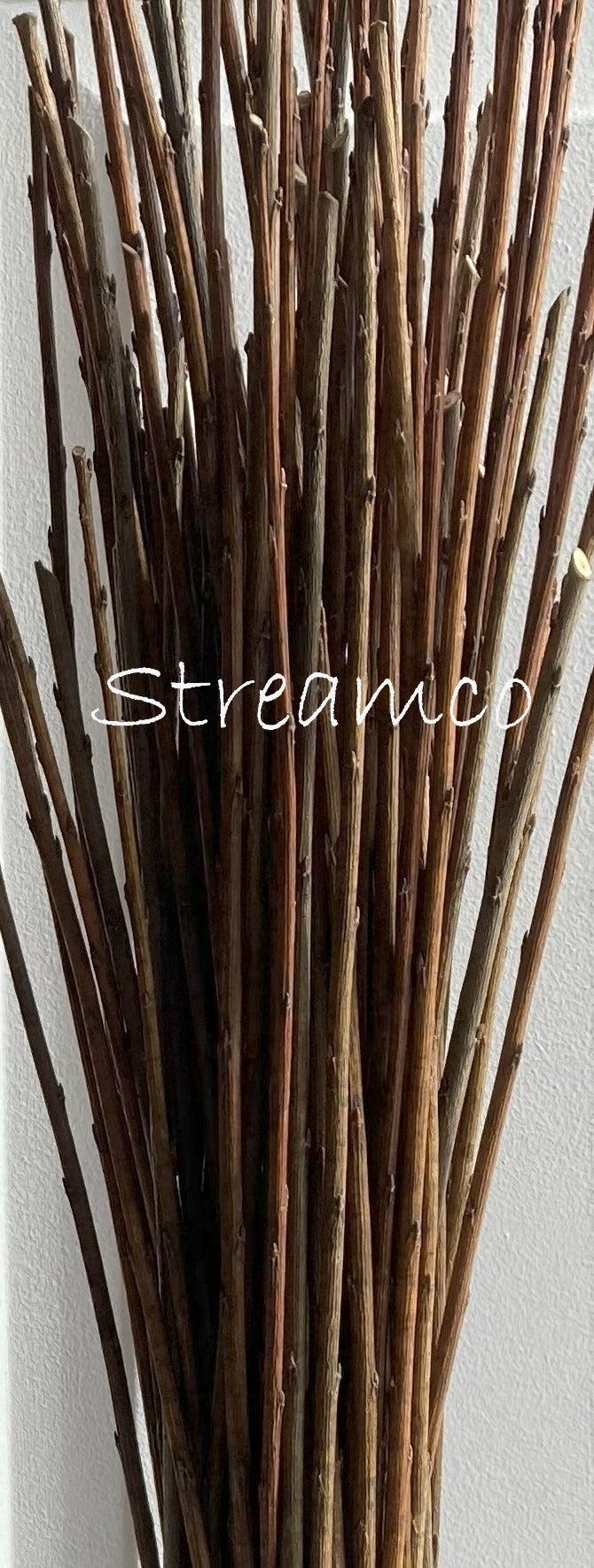 Bunch of brown sticks with 'Streamco' branding on a light background
